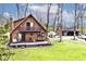 A-frame house boasts a large deck and balcony, complemented by a detached garage and lush green lawn at 8327 S County Road 825 E, Plainfield, IN 46168