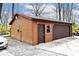 Exterior view of the detached garage featuring a window, entrance door, and roll up door at 8327 S County Road 825 E, Plainfield, IN 46168