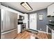 Well-lit kitchen with stainless steel appliances, white cabinets, and a view to the back yard at 8327 S County Road 825 E, Plainfield, IN 46168