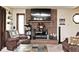 Living room featuring a brick fireplace with TV above, plush seating, and natural light at 8327 S County Road 825 E, Plainfield, IN 46168