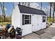 A detached shed with a dark metal roof, white siding and black trim at 8327 S County Road 825 E, Plainfield, IN 46168