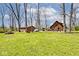 Wide shot of the expansive yard with detached garage and house, showing patio furniture at 8327 S County Road 825 E, Plainfield, IN 46168