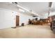 Open basement space with utilitarian features, including a painted floor and industrial lighting at 840 Cottage Ave, Indianapolis, IN 46203