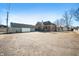 View of brick building with an attached structure and large parking lot at 840 Cottage Ave, Indianapolis, IN 46203