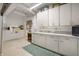 Kitchen with white cabinets, laminate counters, a cross decor, and essential appliances in a compact layout at 840 Cottage Ave, Indianapolis, IN 46203