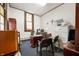 Functional office space with a desk, chairs, filing cabinets, and stained glass window at 840 Cottage Ave, Indianapolis, IN 46203
