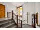 Interior stairway with rail, stained glass window and grandfather clock at 840 Cottage Ave, Indianapolis, IN 46203