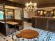 Indoor bar area with classic booth seating, decorative lighting, unique black and white flooring, and a vintage aesthetic at 8801 Ridge Hill Dr, Indianapolis, IN 46217