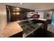 Wet bar featuring granite counters, classic soda fountain, stainless sinks, and views of a unique entertainment area at 8801 Ridge Hill Dr, Indianapolis, IN 46217