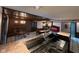 Wet bar with soda fountain, dark wood finishes, brick fireplace in background, and access to multiple rooms for entertaining at 8801 Ridge Hill Dr, Indianapolis, IN 46217