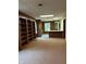 Finished basement area with built-in storage, a wet bar and neutral carpet at 8801 Ridge Hill Dr, Indianapolis, IN 46217