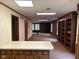 Spacious basement rec room with built-in bookcase and a bar area at 8801 Ridge Hill Dr, Indianapolis, IN 46217