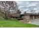 Attractive stone facade on this home with an attached two car garage and a beautifully landscaped front yard at 8801 Ridge Hill Dr, Indianapolis, IN 46217