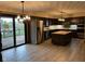 Open kitchen with stainless steel appliances, an island with butcher block countertop and sliding door to deck at 8801 Ridge Hill Dr, Indianapolis, IN 46217