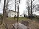 Serene backyard scene with an outdoor table setting, mature trees, and views of the surrounding houses at 8859 Delaney Dr, Fishers, IN 46038
