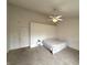 Neutral bedroom with vaulted ceilings, ceiling fan, and comfortable bed next to the door at 8859 Delaney Dr, Fishers, IN 46038