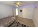 Cozy bedroom with carpeted floors, ceiling fan, and natural light from the open doorway at 8859 Delaney Dr, Fishers, IN 46038