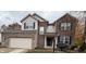 Charming two-story home with a brick and siding exterior and attached two-car garage at 8859 Delaney Dr, Fishers, IN 46038