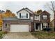 Charming two-story home with brick facade, attached garage and meticulously maintained lawn at 8859 Delaney Dr, Fishers, IN 46038