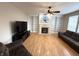 Cozy living room with a fireplace, built-in bookshelves, and hardwood floors at 8859 Delaney Dr, Fishers, IN 46038