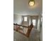 Hallway staircase with chandelier and window light, providing a welcoming and bright transition space at 8859 Delaney Dr, Fishers, IN 46038