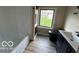 Well-lit bathroom features modern black fixtures and a shower-tub combo at 9218 Wind River Ct, Indianapolis, IN 46234
