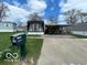 Charming home featuring a covered carport and well-maintained lawn at 9218 Wind River Ct, Indianapolis, IN 46234