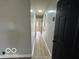 Long hallway with wood laminate flooring and access to other rooms at 9218 Wind River Ct, Indianapolis, IN 46234