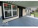 Inviting covered porch featuring newly installed windows and light fixtures at 9218 Wind River Ct, Indianapolis, IN 46234