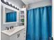 Updated bathroom features a shower with blue curtain and a sink with modern hardware at 936 N Oxford St, Indianapolis, IN 46201