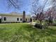 Spacious backyard with a brick patio, tall chimney and nice, green, well-kept grass at 10404 Trillium Ct, Noblesville, IN 46060