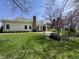 Spacious backyard with a brick patio, tall chimney and nice, green, well-kept grass at 10404 Trillium Ct, Noblesville, IN 46060
