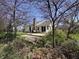 Backyard with a brick patio, blossoming trees, well kept grass and some flowers blooming at 10404 Trillium Ct, Noblesville, IN 46060