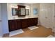 Bathroom featuring double sink vanity with wooden cabinets and large mirrors at 10404 Trillium Ct, Noblesville, IN 46060