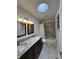 Bathroom featuring double vanity, skylight, and tiled shower with tub at 10404 Trillium Ct, Noblesville, IN 46060
