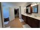Spacious bathroom with dual sink vanity, closet, and wood-look vinyl flooring at 10404 Trillium Ct, Noblesville, IN 46060