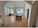 Open dining area with light wood floors, a modern chandelier, and ample natural light at 10404 Trillium Ct, Noblesville, IN 46060