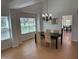 Bright dining room with hardwood floors, elegant chandelier, and views of the backyard at 10404 Trillium Ct, Noblesville, IN 46060