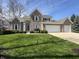 Charming two-story brick home with a well-manicured lawn and three-car garage at 10404 Trillium Ct, Noblesville, IN 46060