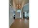 Elegant foyer with high ceilings, chandelier lighting, and wood-style flooring at 10404 Trillium Ct, Noblesville, IN 46060