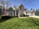 A beautiful brick home with a three-car garage and well-manicured landscaping at 10404 Trillium Ct, Noblesville, IN 46060
