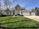 A beautiful brick home with a three-car garage and well-manicured landscaping at 10404 Trillium Ct, Noblesville, IN 46060