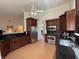 Open kitchen featuring wooden cabinets, stainless steel appliances, and modern lighting at 10404 Trillium Ct, Noblesville, IN 46060