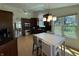 Modern kitchen with stainless steel appliances, dark wood cabinetry, and a cozy breakfast nook at 10404 Trillium Ct, Noblesville, IN 46060