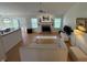 Open-concept living room featuring fireplace, hardwood floors, and an outdoor view at 10404 Trillium Ct, Noblesville, IN 46060