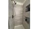 Updated tile shower with built-in shampoo niches and modern shower head at 10404 Trillium Ct, Noblesville, IN 46060