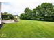 Expansive backyard featuring mature trees, lush lawn, and a covered pergola at 11648 Stickney Ct, Fishers, IN 46037