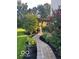 Side view of paver walkway surrounded by landscaping, leading to a pergola at 11648 Stickney Ct, Fishers, IN 46037