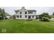 Spacious backyard featuring a well-maintained lawn, patio area, and lush landscaping at 11648 Stickney Ct, Fishers, IN 46037