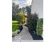 Paver walkway with landscaping leads to pergola in this backyard at 11648 Stickney Ct, Fishers, IN 46037